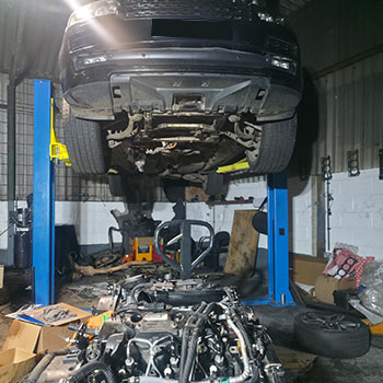 Jaguar raised on workshop lift for engine replacement