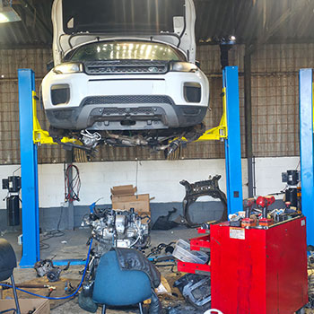 Range Rover Evoque lifted for engine removal and fitting