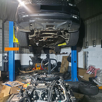 Land Rover engine removal in workshop
