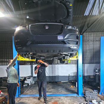 Jaguar lifted for engine removal and installation